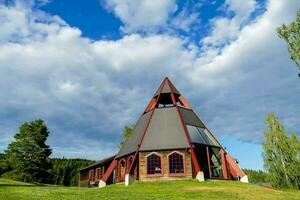 the church is made of wood and has a triangular roof photo