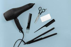 Hairdresser set with various accessories on blue background photo