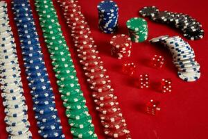 Stack of poker chips on red background at casino photo