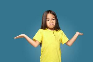 Surprised girl with spread arms on blue background photo