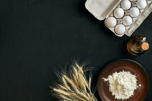 Preparation cooking baking kitchen table brown dishes ware fresh grocery different ingredients eggs, flour, oil, stuff top view photo