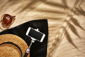 Top view of summer accessories on sandy beach photo