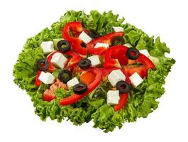 Greek salad with greens, sliced vegetables, olives and feta cheese isolated on white photo