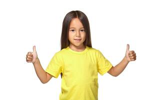 Girl in yellow t-shirt shows her hands with thumbs photo