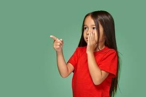 Young girl in red t-shirt is afraid of something photo