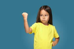 Angry little kid showing frustration and disagreement photo