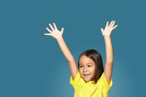 Little girl in raising her hands up photo