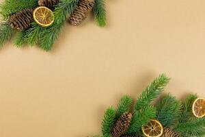 Christmas flat lay background with fir tree branches, pine cones and christmas decorations on craft paper background. Top view. Copy space. photo