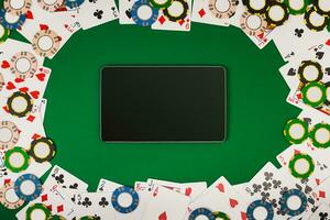 Online poker game with digital tablet, chips and cards photo