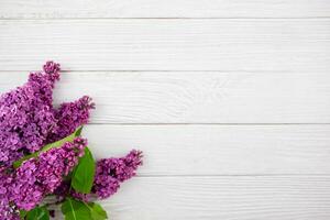 Beautiful spring lilac flowers on white wooden background. Valentines, womens, mothers day, easter, birthday, wedding or holiday flat lay. Top view. Copy space. photo