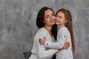 Eemotions of a beautiful young mother and her little daughter who spend time together photo