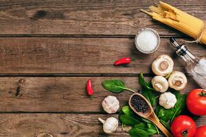 Italian food ingredients for the preparation pasta on wooden background photo