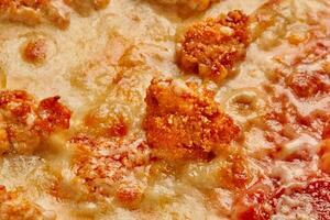 Macro shot of pizza topping with deep-fried chicken, tomatoes and cheese photo