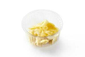 Plastic bowl of pickled ginger, traditional Japanese sushi accompaniment photo