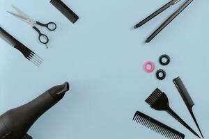 Hairdresser set with various accessories on blue background photo