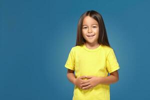 Little girl in yellow t-shirt is smiling photo