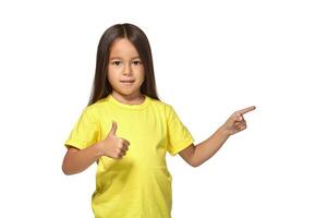 Girl in yellow t-shirt shows her hands with thumbs photo
