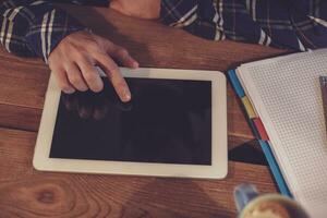 Man using tablet works. White tablet with blank screen in a man photo