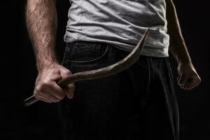 masculino delincuente con un chatarra. en negro antecedentes a el estudio foto