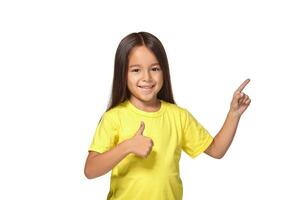 Girl in yellow t-shirt shows her hands with thumbs photo