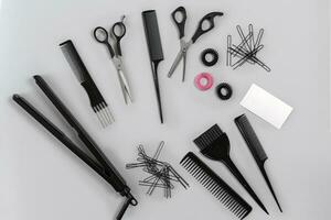 Hairdresser set with various accessories on gray background photo