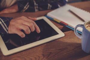 Man using tablet works. White tablet with blank screen in a man photo