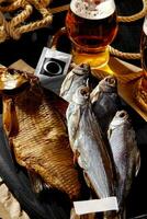 Various whole air-dried and smoked fish served with amber lager photo