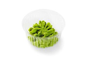 Plastic container of wasabi, traditional Japanese pungent condiment photo