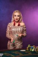 Blonde woman with a perfect hairstyle and bright make-up is posing with gambling chips in her hands. Casino, poker. photo