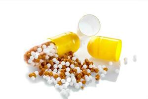 Macro yellow medical pill tablet with pellet, microgranules isolated on white photo