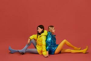 Two pretty girls in puffs posing for the camera in the studio photo