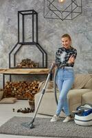 Slim woman cleaning with vacuum cleaner carpet photo