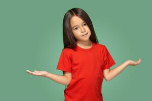 Surprised girl with spread arms isolated on green background photo