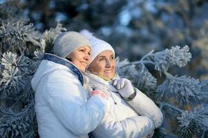 Portrait of happy women in winter clothes posing outdoors photo