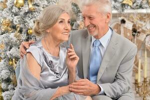 Close up portrait of old couple with Christmas present photo