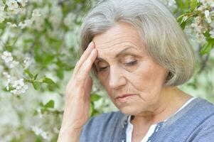 Close up portrait of unhappy senior woman photo