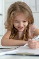 Cute and happy little girl children using laptop computer photo