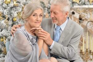 Close up portrait of old couple with Christmas present photo