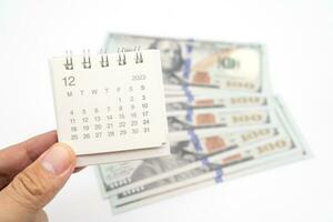 Envelope With Money And Calendar. opens envelope with money, dollars. Pension Concept. Bonus Money. isolated on white background. photo