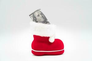 Dollars with boot of Santa Claus on white background. Merry Christmas and Happy New Year Concept. Xmas background. copy space. photo