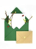 Two envelopes with space for text. Spring invitation. Envelope with twigs and leaves. Craft paper photo
