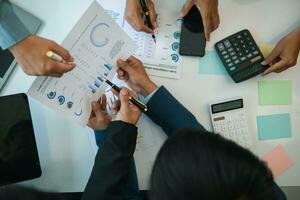 group businessmen and investors met together in conference room to view annual results their investments in business together in order to plan marketing doing business that would produce better result photo