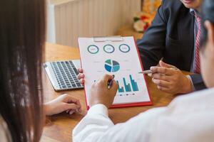 group businessmen and investors met together in conference room to view annual results their investments in business together in order to plan marketing doing business that would produce better result photo