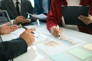 group businessmen and investors met together in conference room to view annual results their investments in business together in order to plan marketing doing business that would produce better result photo