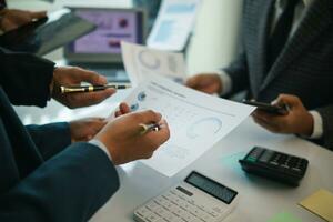 group businessmen and investors met together in conference room to view annual results their investments in business together in order to plan marketing doing business that would produce better result photo