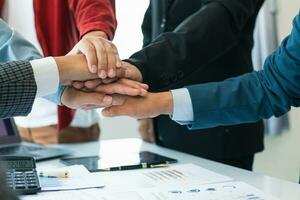 Businessmen and investors join hands symbolize friendship and cooperation in business success. concepts of group of businessmen and investors joining hands symbolize cooperation in doing business. photo