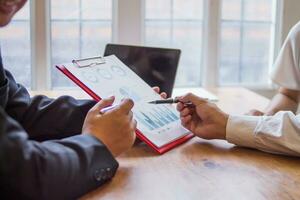 group businessmen and investors met together in conference room to view annual results their investments in business together in order to plan marketing doing business that would produce better result photo