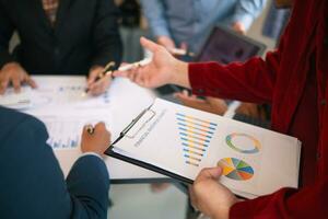 group businessmen and investors met together in conference room to view annual results their investments in business together in order to plan marketing doing business that would produce better result photo