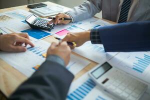 group businessmen and investors met together in conference room to view annual results their investments in business together in order to plan marketing doing business that would produce better result photo