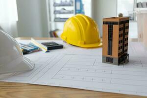 Building models and blueprints are placed on work desks in the construction engineering team offices to plan construction to achieve their goals and to simulate building models for clients to see. photo